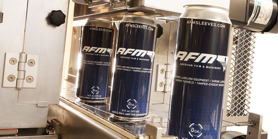 Three AFM branded coffee cups on a coffee machine.